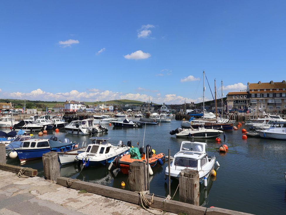A marina with boats and buildings at Rope Cottage in Bridport
