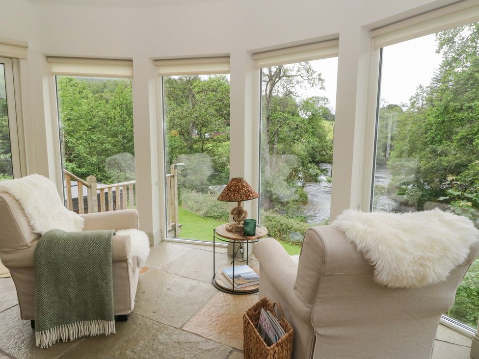 A snug with armchairs and a coffee table at Glen Lochay Lodge in Killin