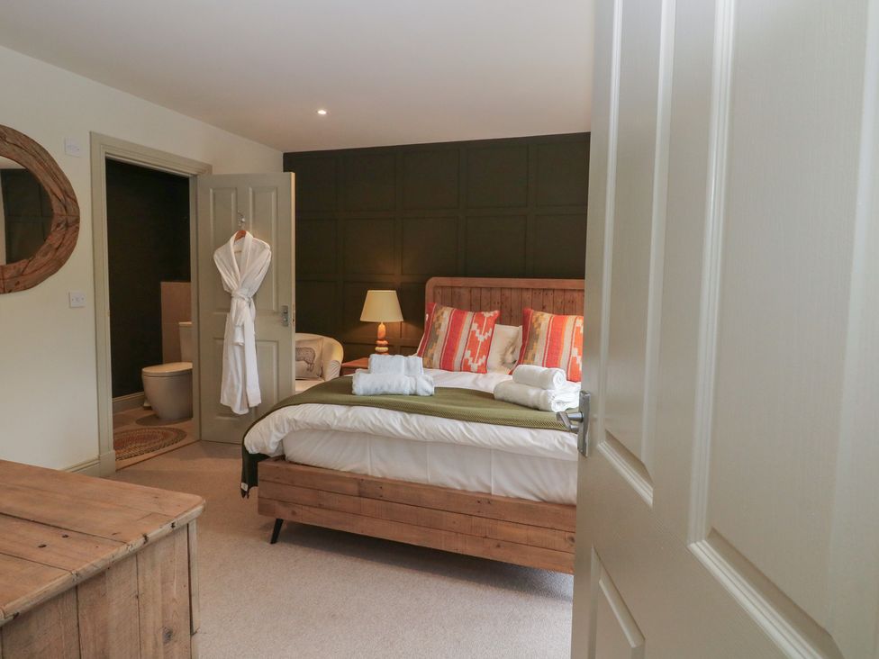 A bedroom with a bed and attached bathroom at Glen Lochay Lodge in Killin