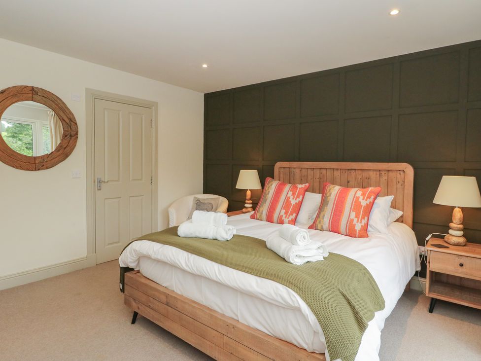 A bedroom with a bed and side tables at Glen Lochay Lodge in Killin