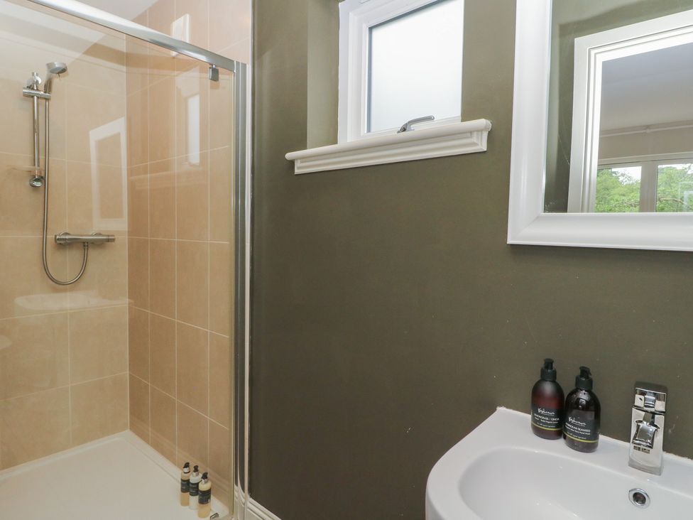 A bathroom with a shower and sink at Glen Lochay Lodge in Killin