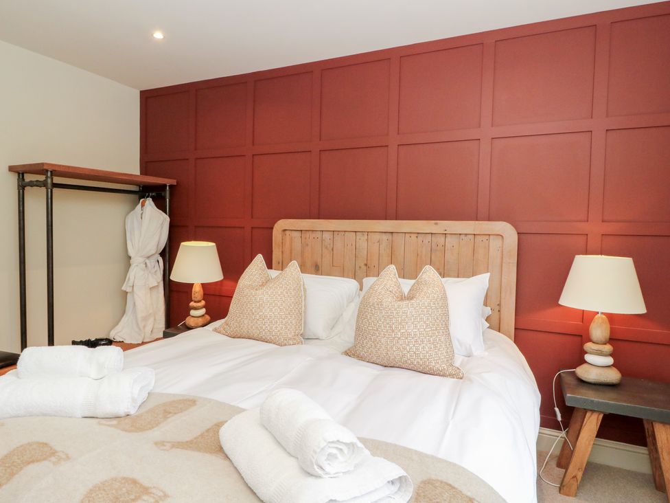 A bedroom with a bed and shelves at Glen Lochay Lodge in Killin