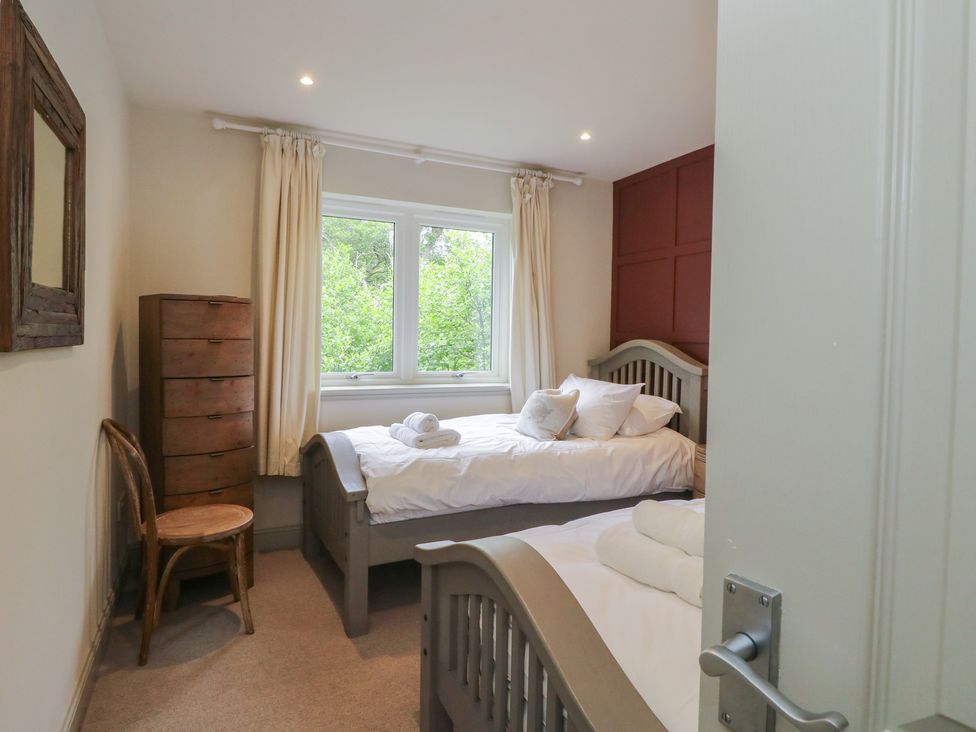 A bedroom with two beds and a window at Glen Lochay Lodge in Killin