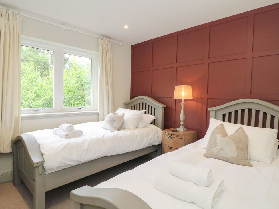 A bedroom with two beds and a window at Glen Lochay Lodge in Killin