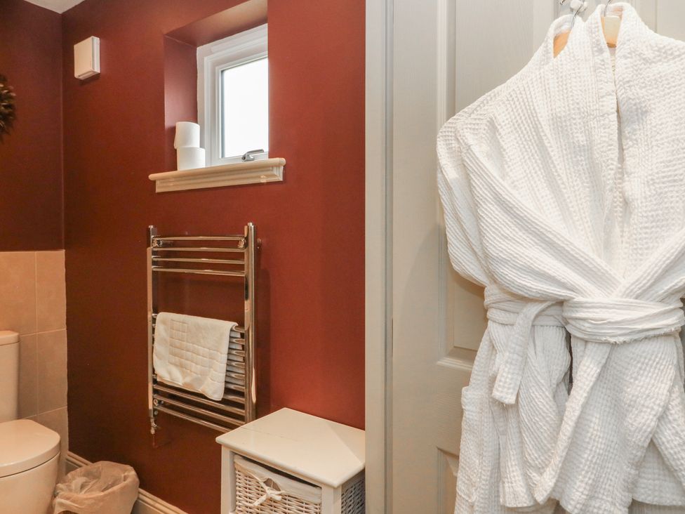 A bathroom with a toilet and towel rack at Glen Lochay Lodge in Killin