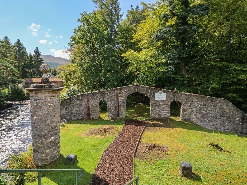 An archway and pillar near a river at Glen Lochay Lodge in Killin