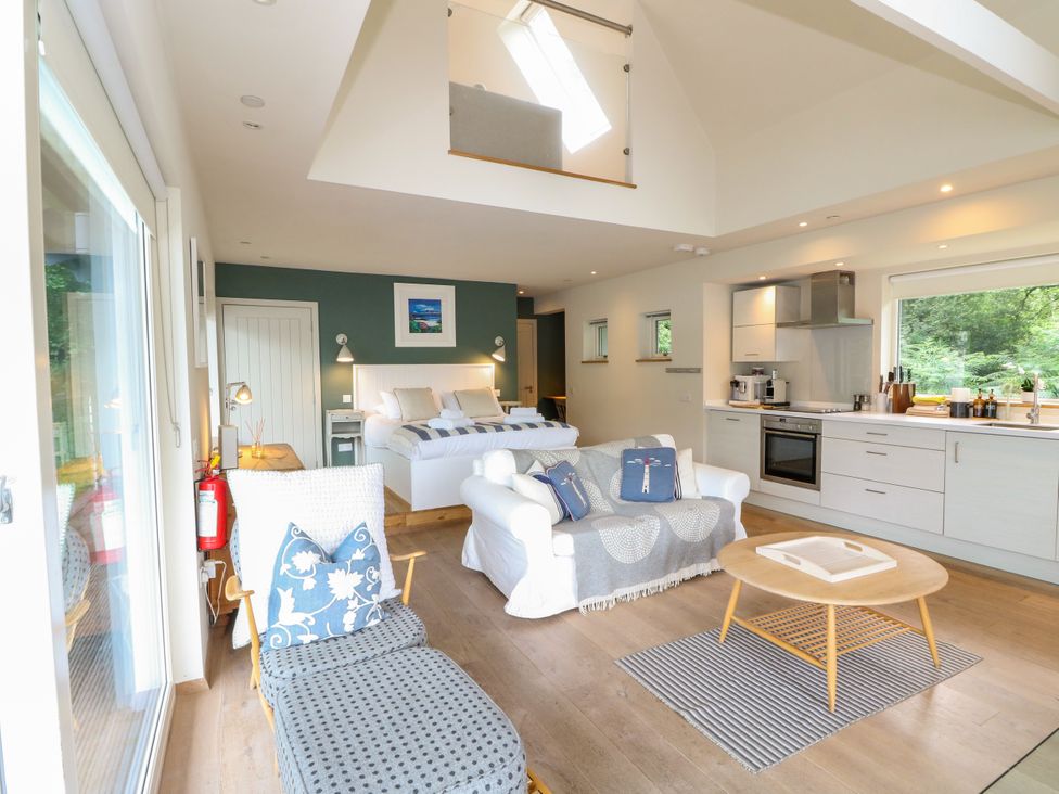 A living room with a sofa and coffee table at Osprey Boathouse in Killin