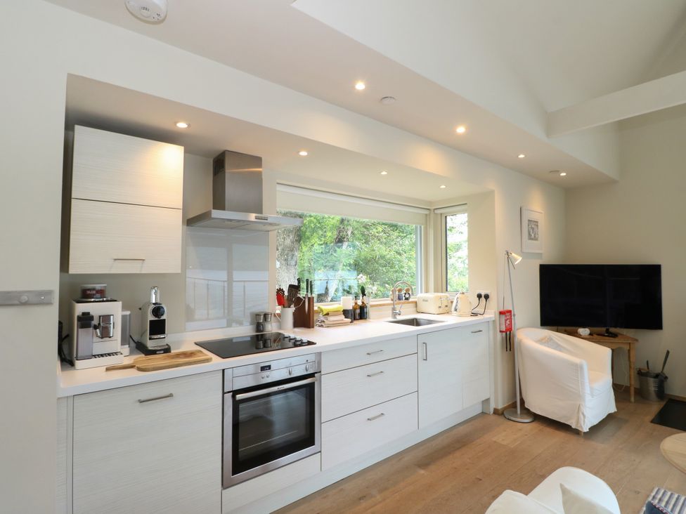 A kitchen with modern appliances and large windows at Osprey Boathouse in Killin