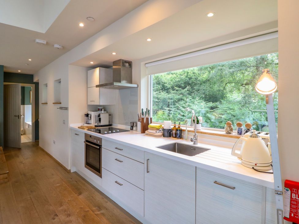 A kitchen with a sink and stove at Osprey Boathouse in Killin