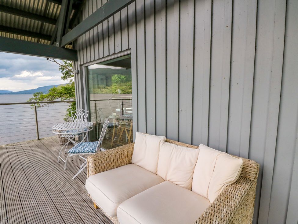 An outdoor seating area with a sofa and a table at Osprey Boathouse in Killin