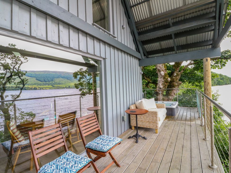 An outdoor seating area with furniture and a view at Dipper Boathouse in Killin