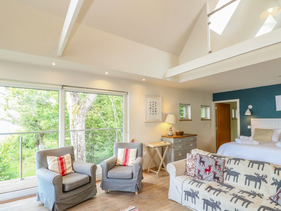 A living room with a sofa and armchairs at Dipper Boathouse in Killin