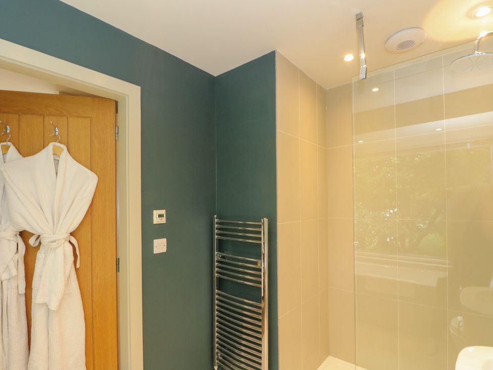 A bathroom with a heated towel rail and shower at Dipper Boathouse in Killin