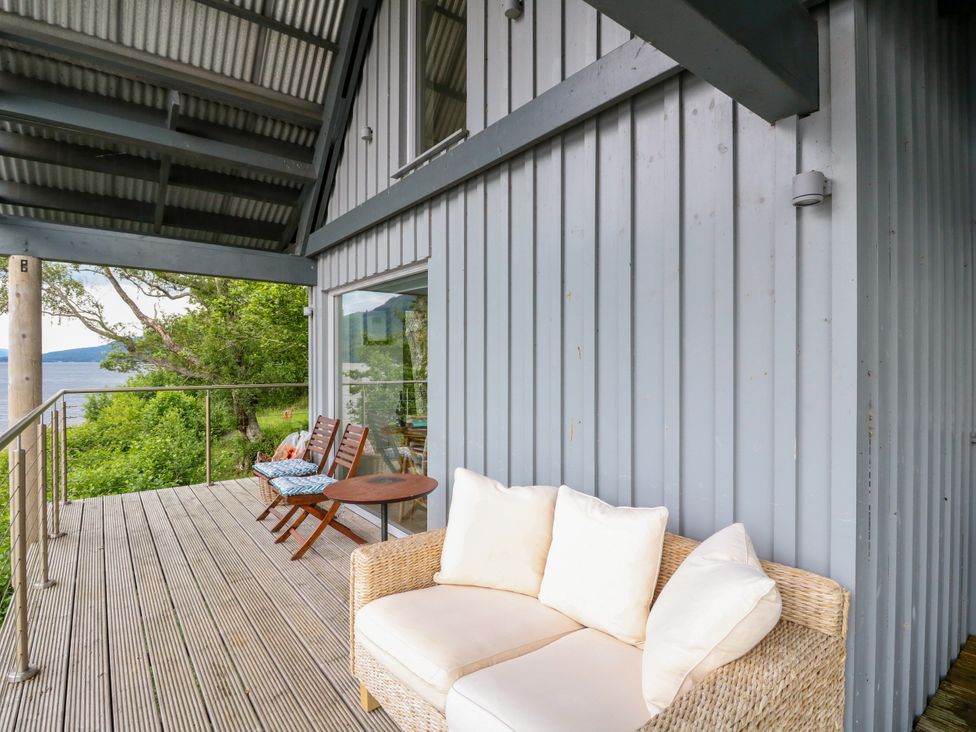 An outdoor seating area with furniture at Dipper Boathouse in Killin