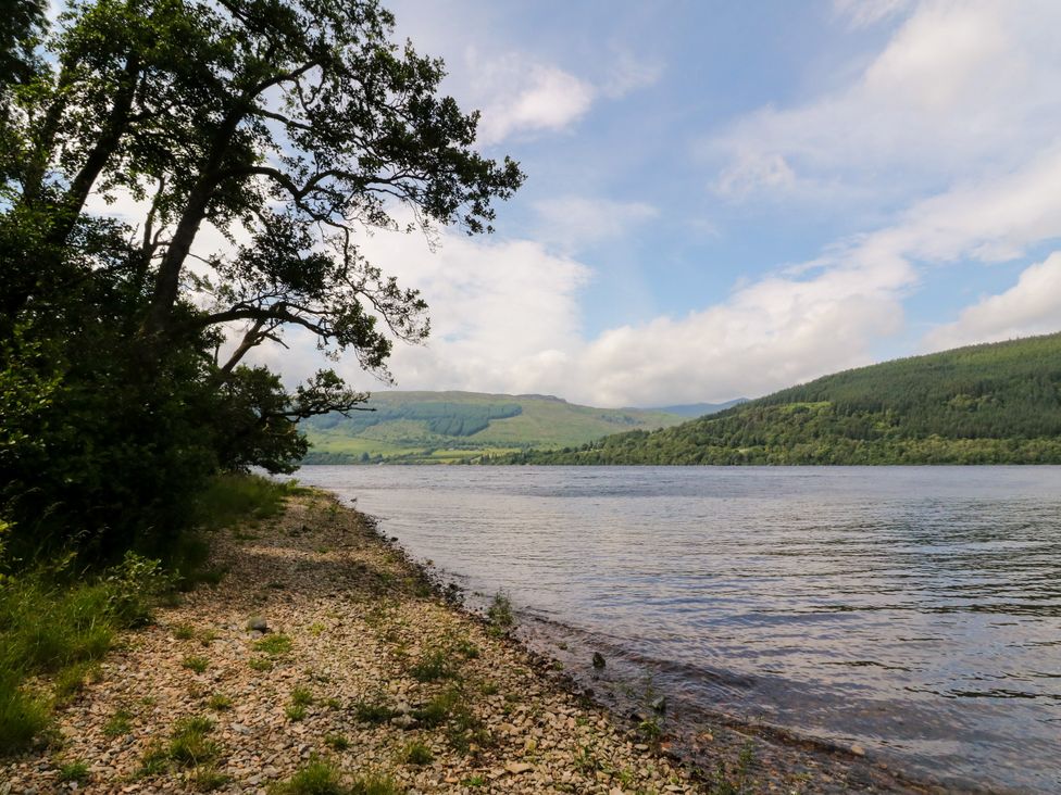 A river view with trees and hills at Dipper Boathouse in Killin