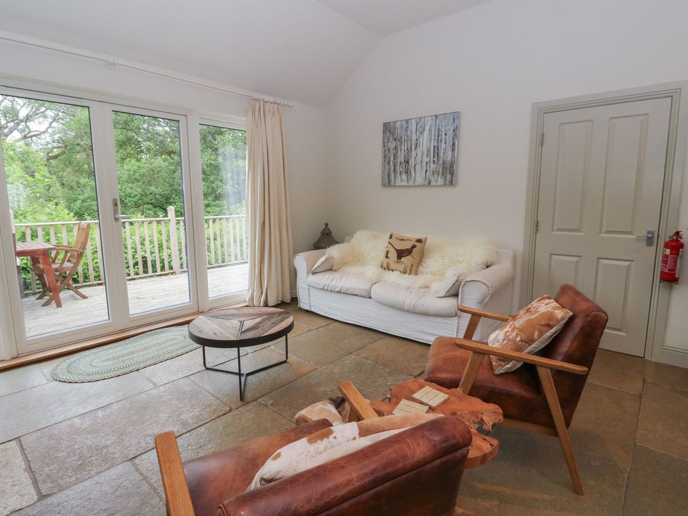 A living room with a sofa and coffee table at Ghillie's Cottage Killin