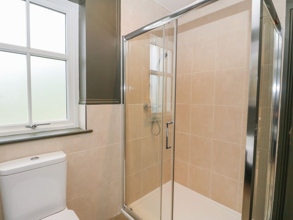 A bathroom with a shower and toilet at Ghillie's Cottage in Killin