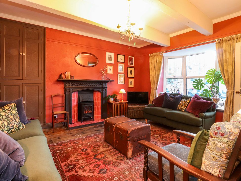 A living room with a fireplace and sofa at Devonshire House in Settle