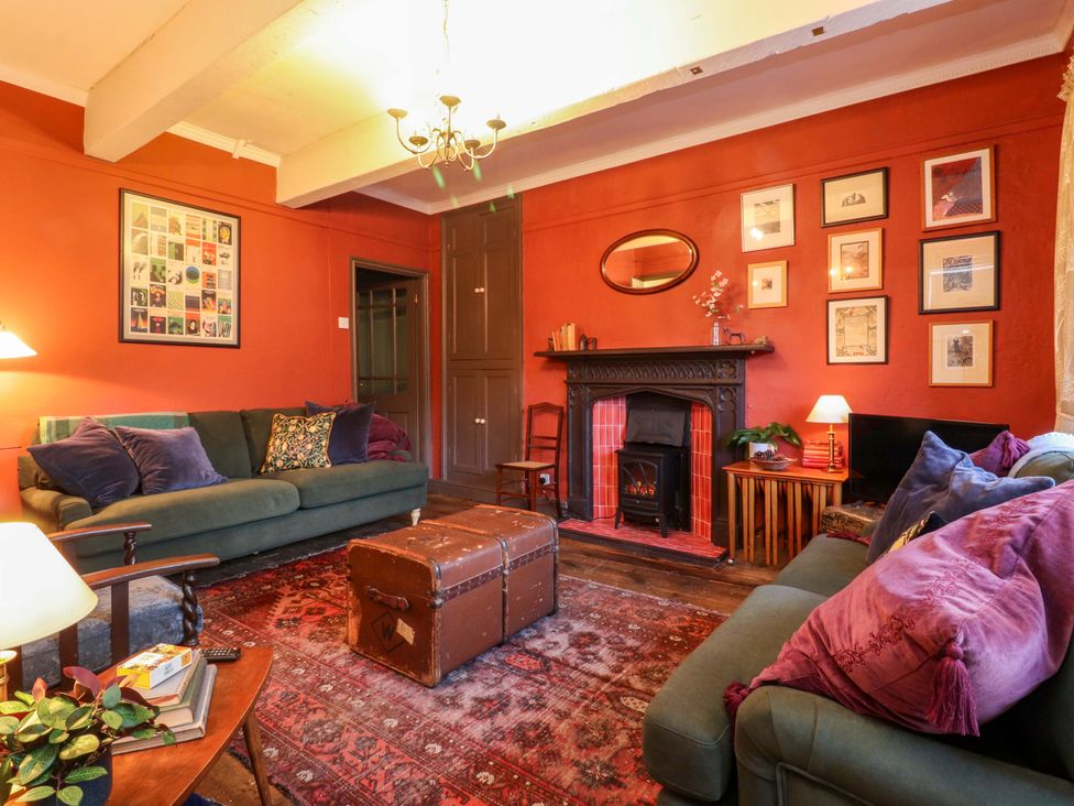 A living room with a sofa and fireplace at Devonshire House in Settle