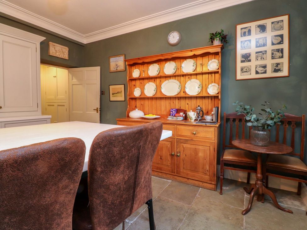 A kitchen with a dining table and chairs at Devonshire House in Settle