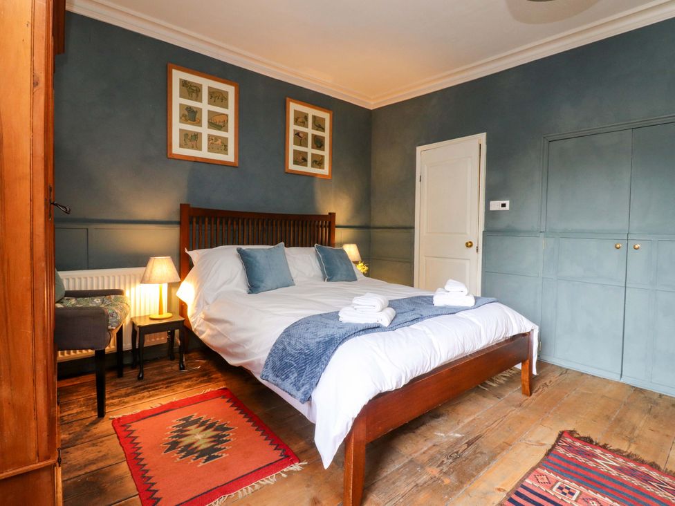 A bedroom with a bed and bedside table at Devonshire House in Settle