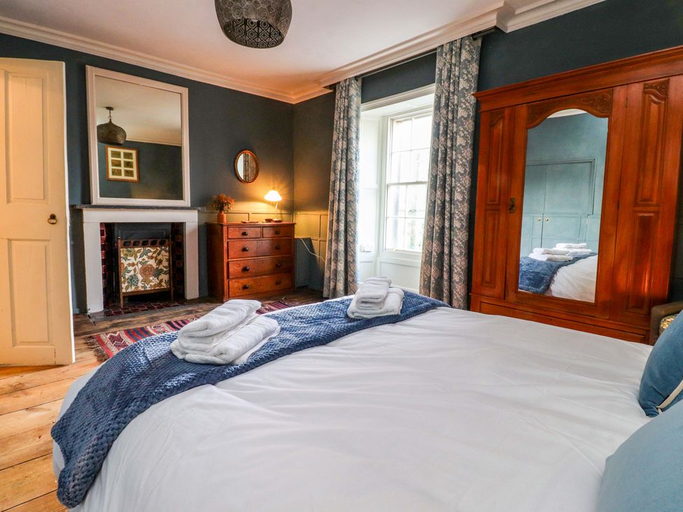 A bedroom with a bed and wardrobe at Devonshire House in Settle