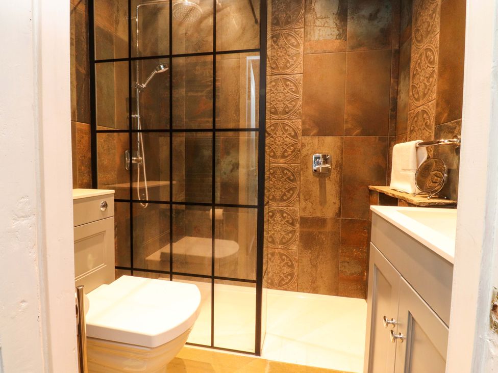 A bathroom with shower, toilet, and sink at Devonshire House in Settle