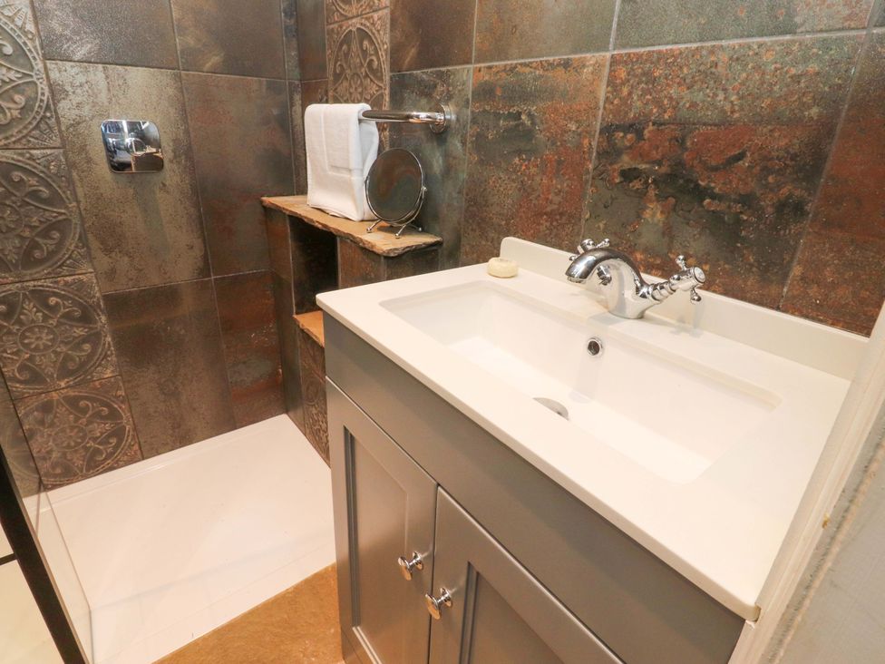 A bathroom with a sink and shower at Devonshire House in Settle