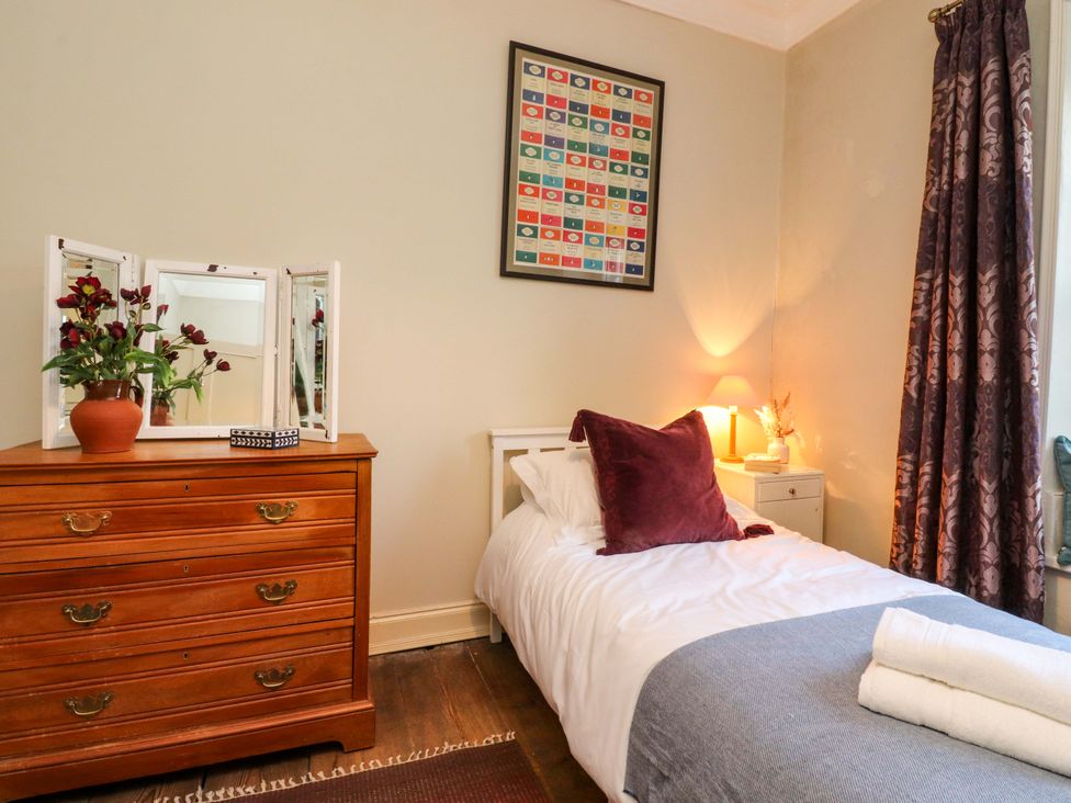 A bedroom with a single bed and a dresser at Devonshire House in Settle