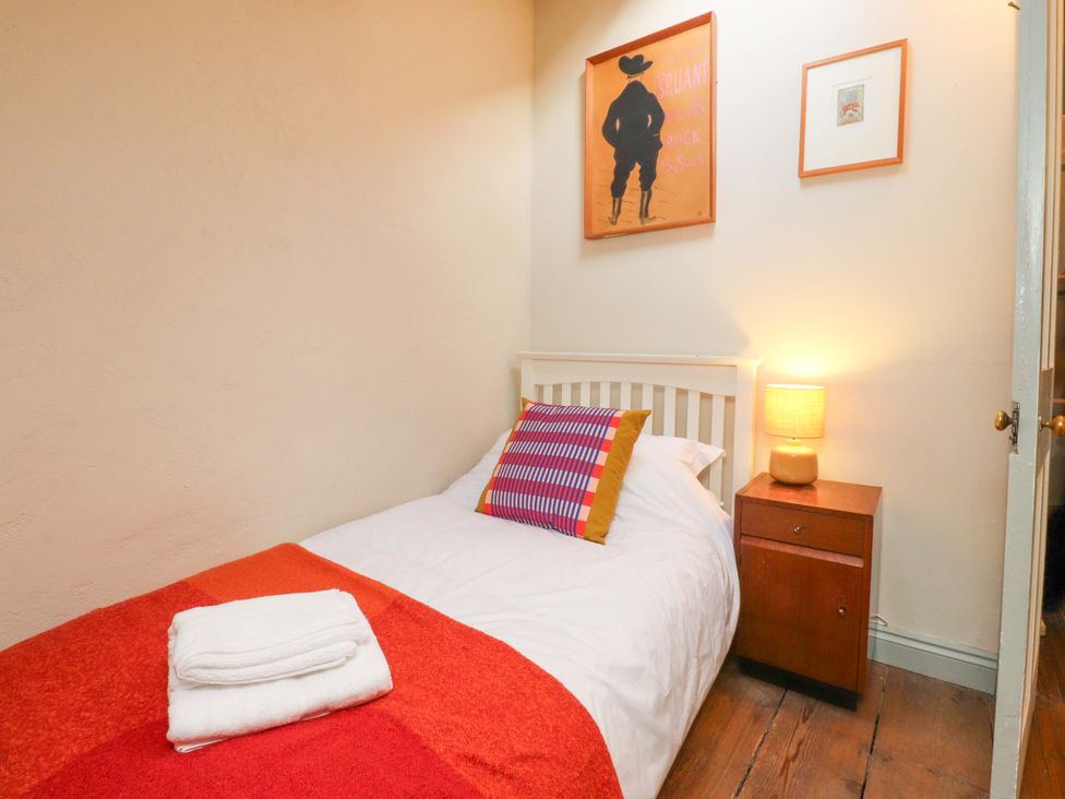 A bedroom with a bed and nightstand at Devonshire House in Settle