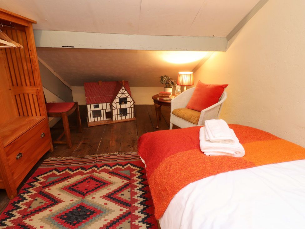 A bedroom with a bed and a dolls house at Devonshire House in Settle