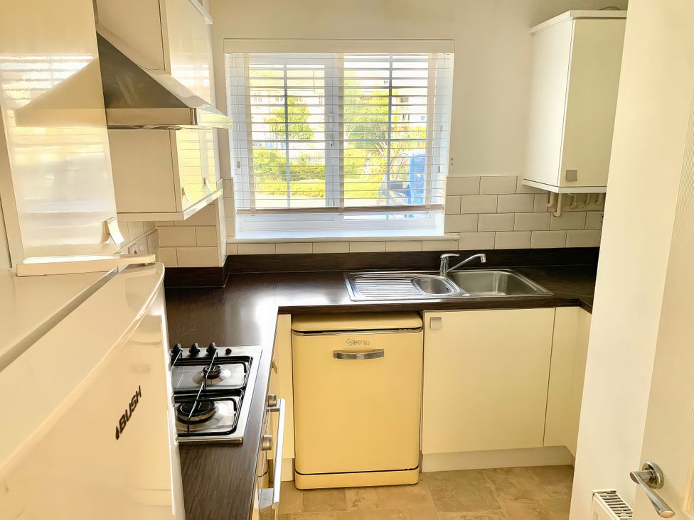 A kitchen with a sink and stove at 23 Wheathouse Grove