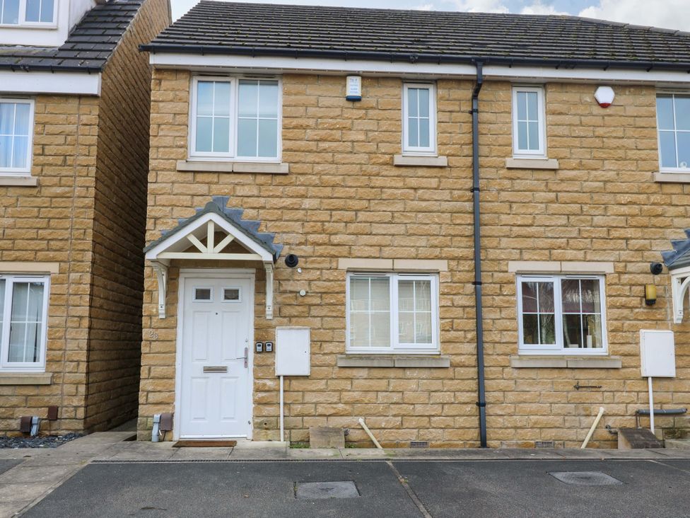 A house with a front door and windows at Cottage Holiday Home in Huddersfield
