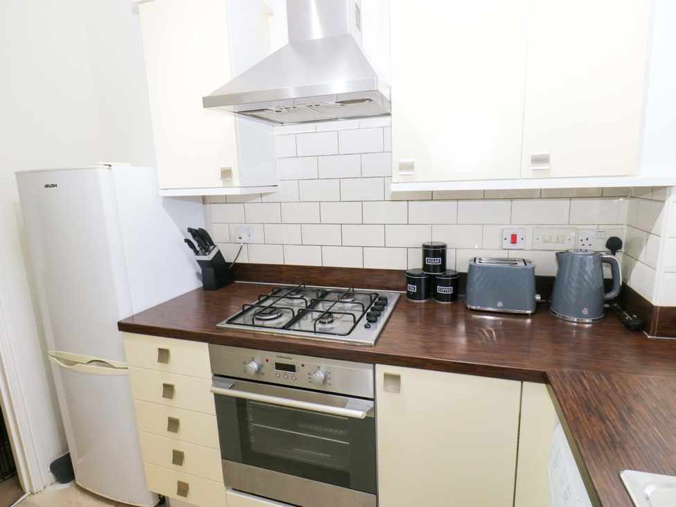 A kitchen with appliances and countertops at Cottage Holiday Home in Huddersfield