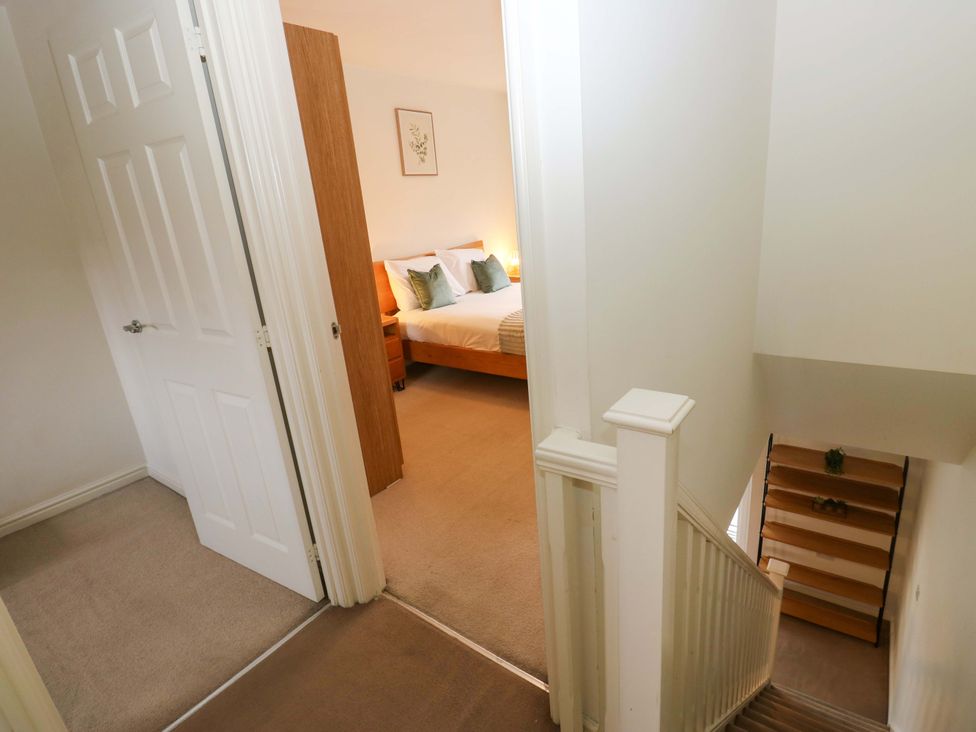 A bedroom with a bed and doorways at Cottage Holiday Home in Huddersfield