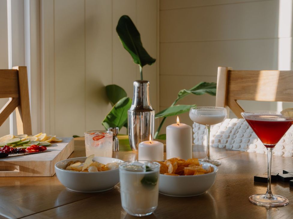 A dining room table with drinks and fruit at The Elton in Kings Cliffe