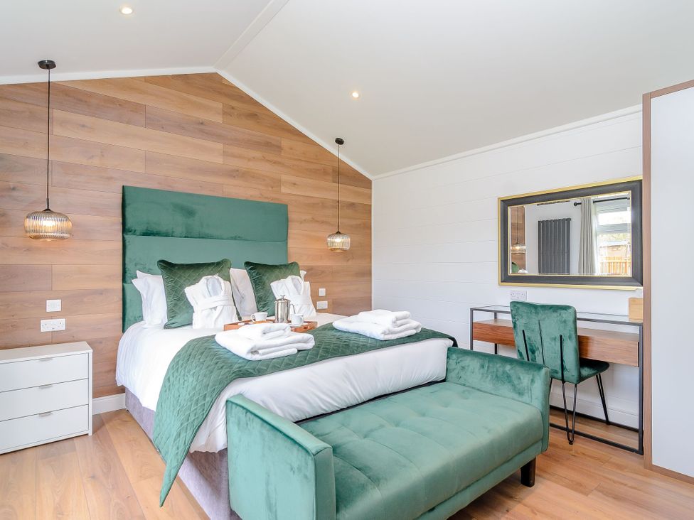 A bedroom with a bed and desk at The Castor in Kings Cliffe