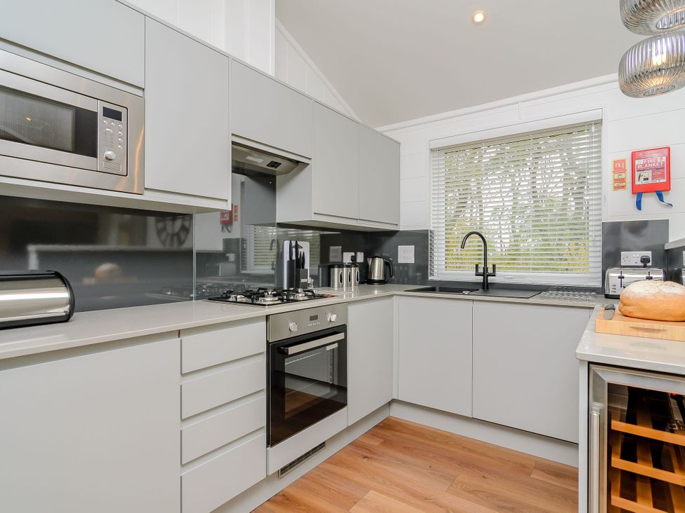 A kitchen with appliances including a microwave and oven at The Castor in Kings Cliffe
