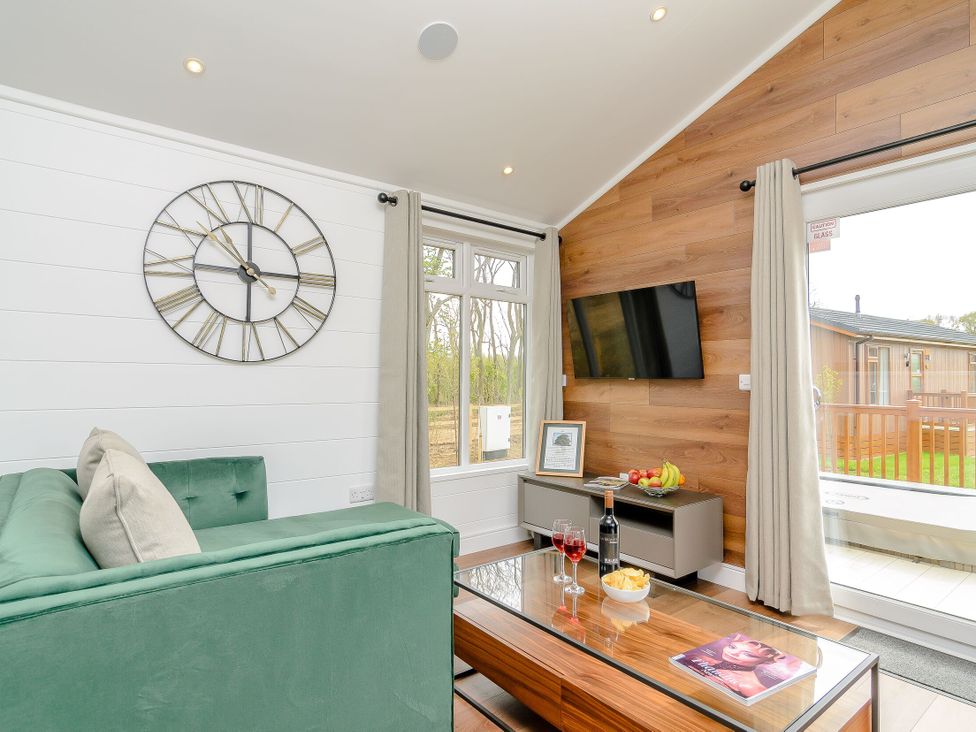 A living room with a sofa and coffee table at The Castor in Kings Cliffe