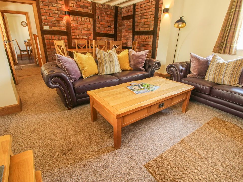 A living room with leather sofas and a wooden coffee table at 1 Clarkes Lane in St Martins