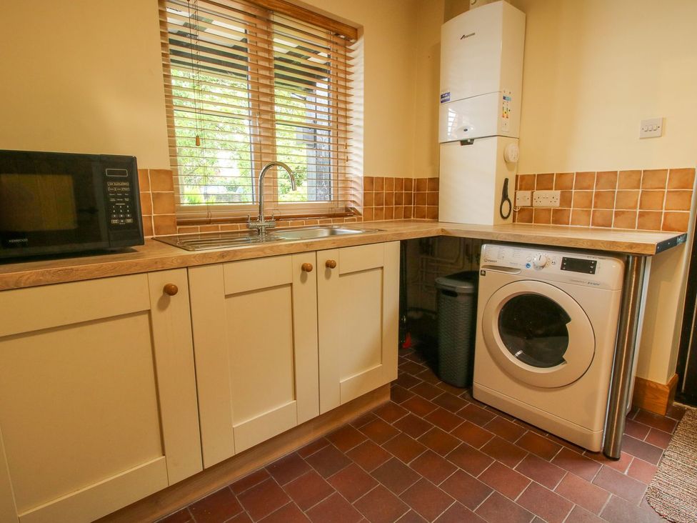 A kitchen with a sink and microwave at 1 Clarkes Lane in St Martins