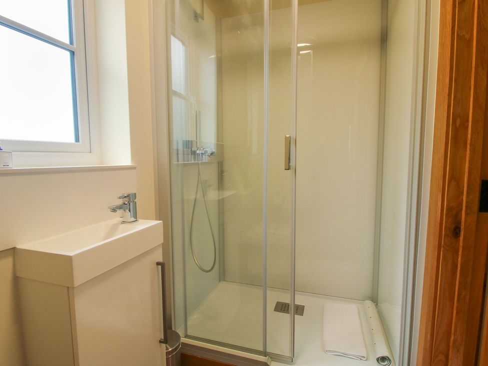 A bathroom with a shower and a washbasin at 1 Clarkes Lane St Martins