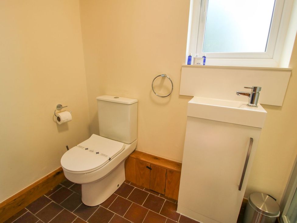 A bathroom with a toilet and sink at 1 Clarkes Lane St Martins