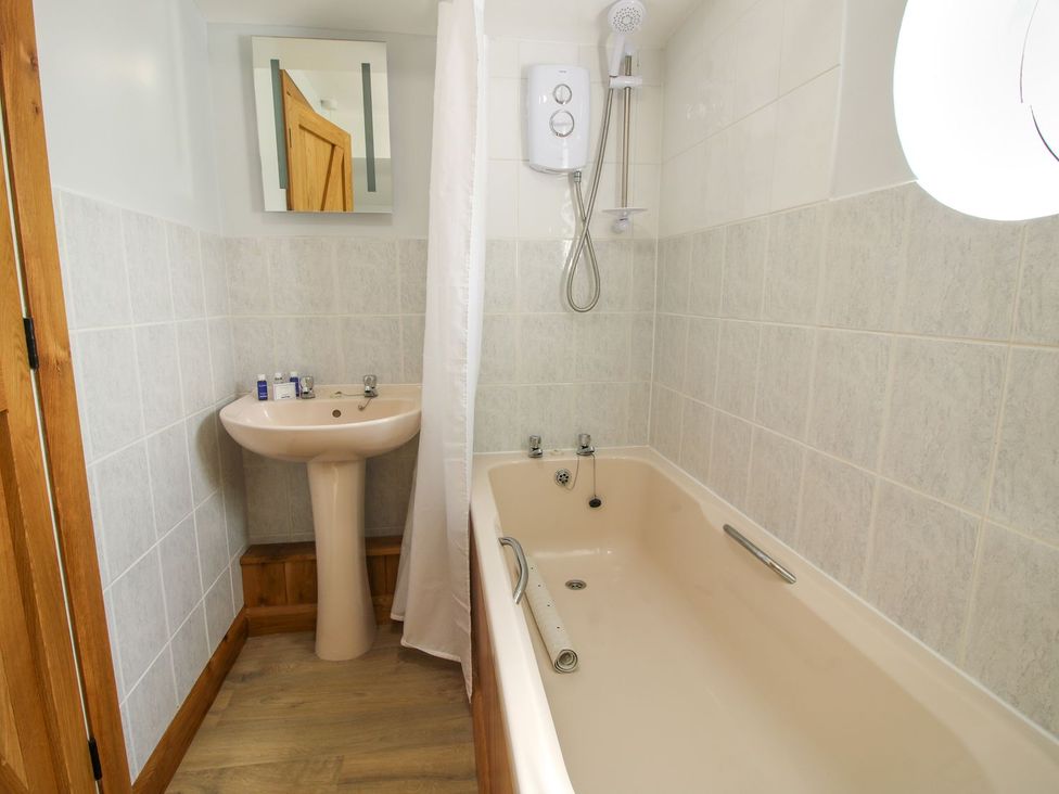 A bathroom with bathtub, sink, and shower at 1 Clarkes Lane in St Martins