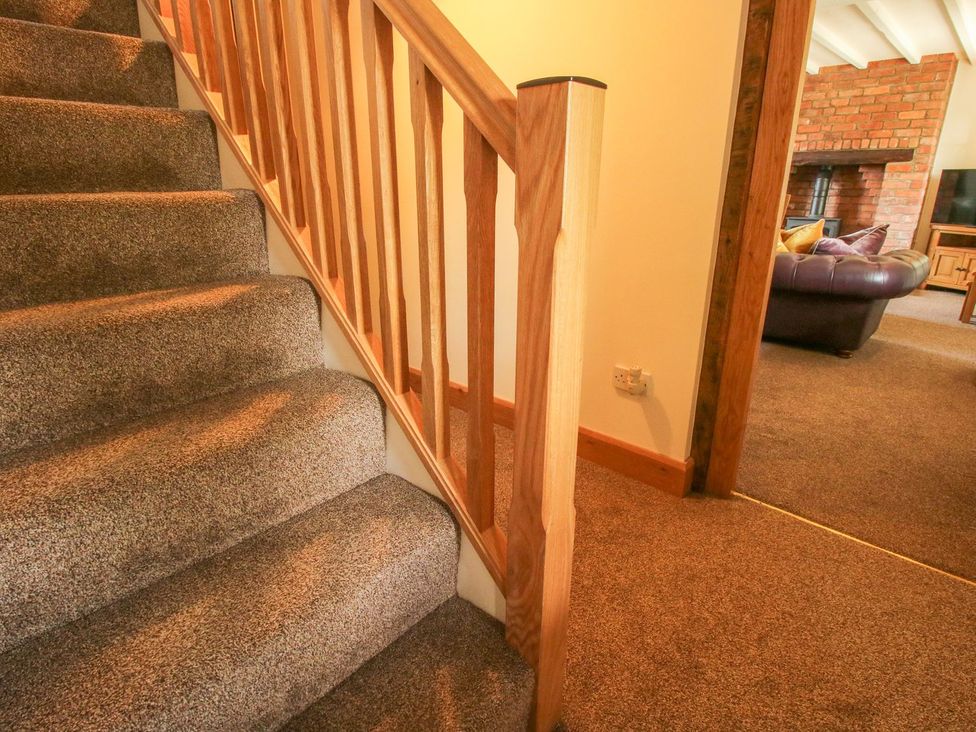 A staircase with carpet and wooden railing at 1 Clarkes Lane St Martins