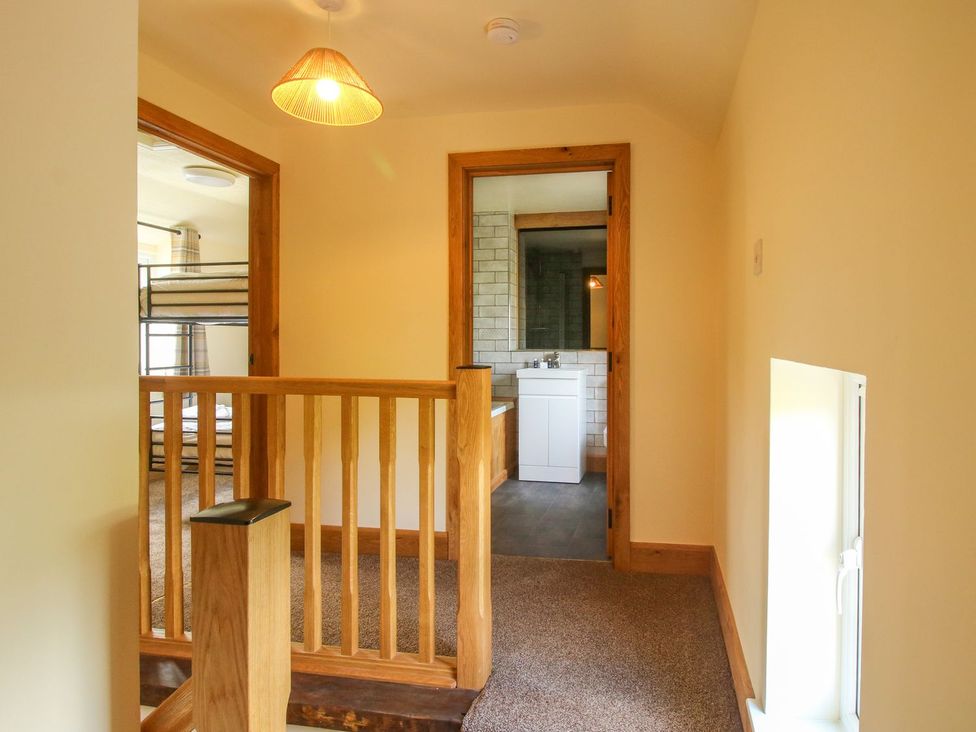 A hallway with a staircase and doors leading to rooms at 1 Clarkes Lane St Martins