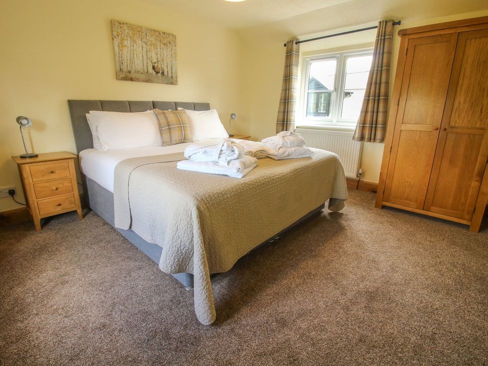 A bedroom with a bed and wardrobe at 1 Clarkes Lane in St Martins