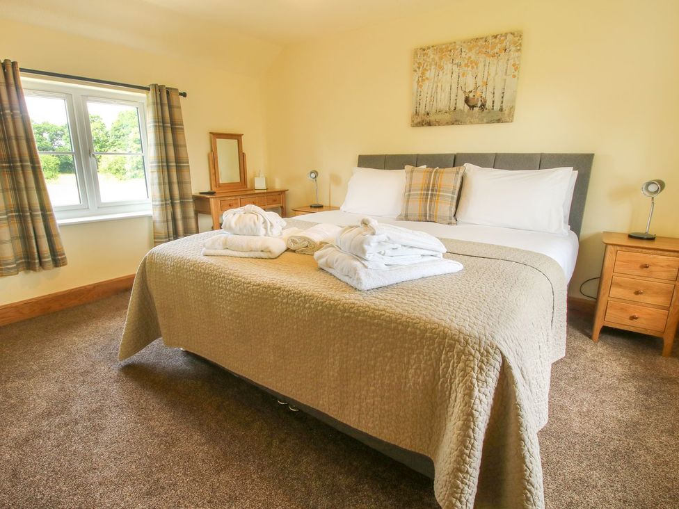 A bedroom with a bed and window at 1 Clarkes Lane St Martins