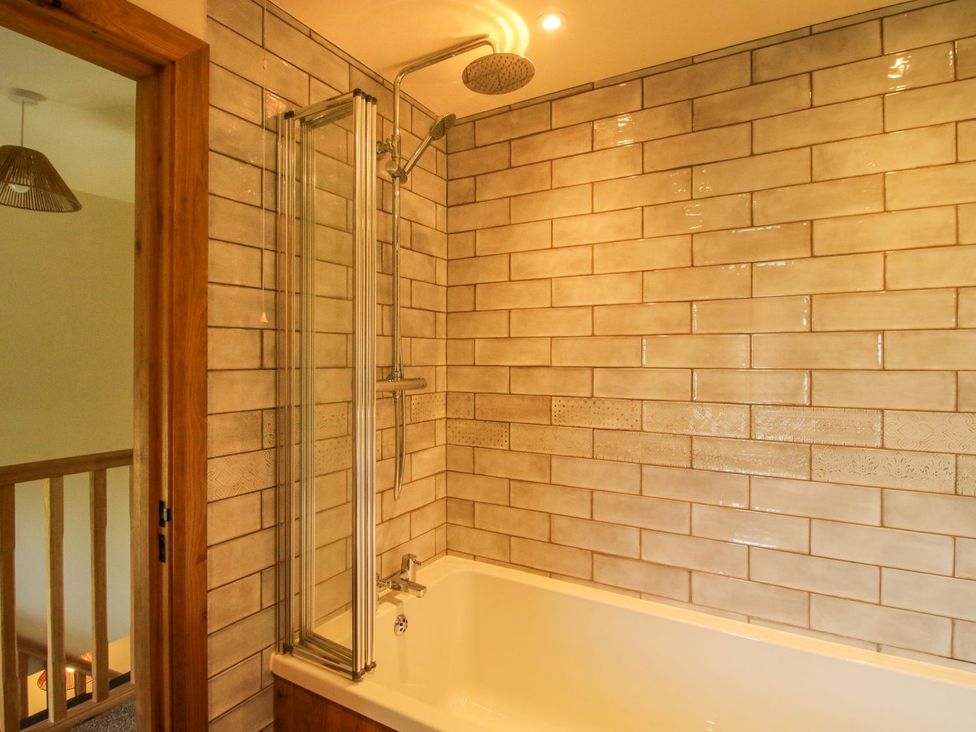 A bathroom with a bathtub and shower at 1 Clarkes Lane St Martins