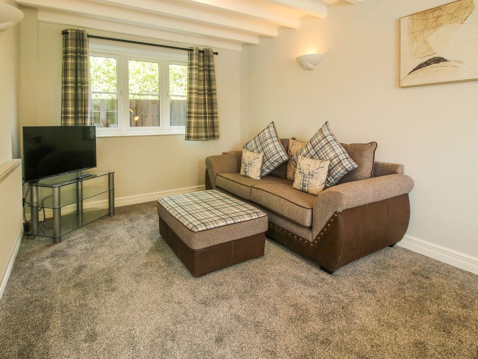 A living room with a sofa and television at 1 Clarkes Lane in St Martins